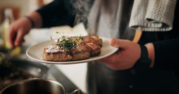chef plating grilled ribeye steak